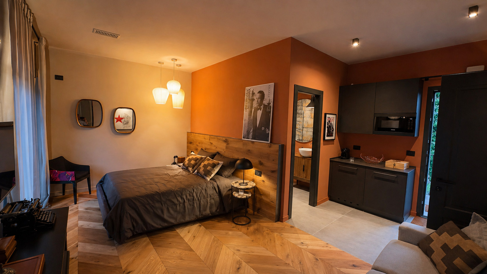 Master bedroom with terracotta wall, oak chevron floor and Sergio Leone artwork